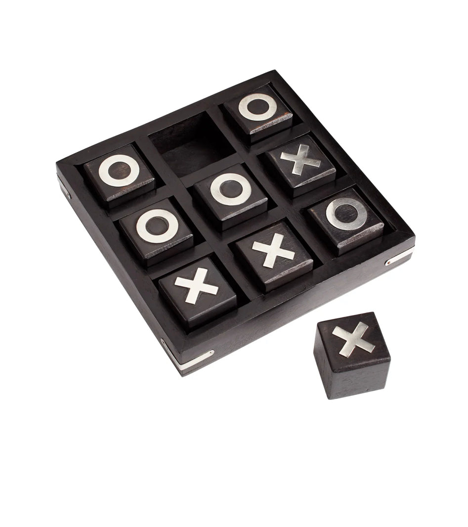 This interactive puzzle inspired game sculpture is all about the x and the o. Three in a row on a coffee table wins in this black and white finished piece.  Qty Available: 20  Dimensions: L 7.00 X W 7.00 X H 1.75  Weight: 1.7 lbs.  Finish: Black and White Materials: Wood