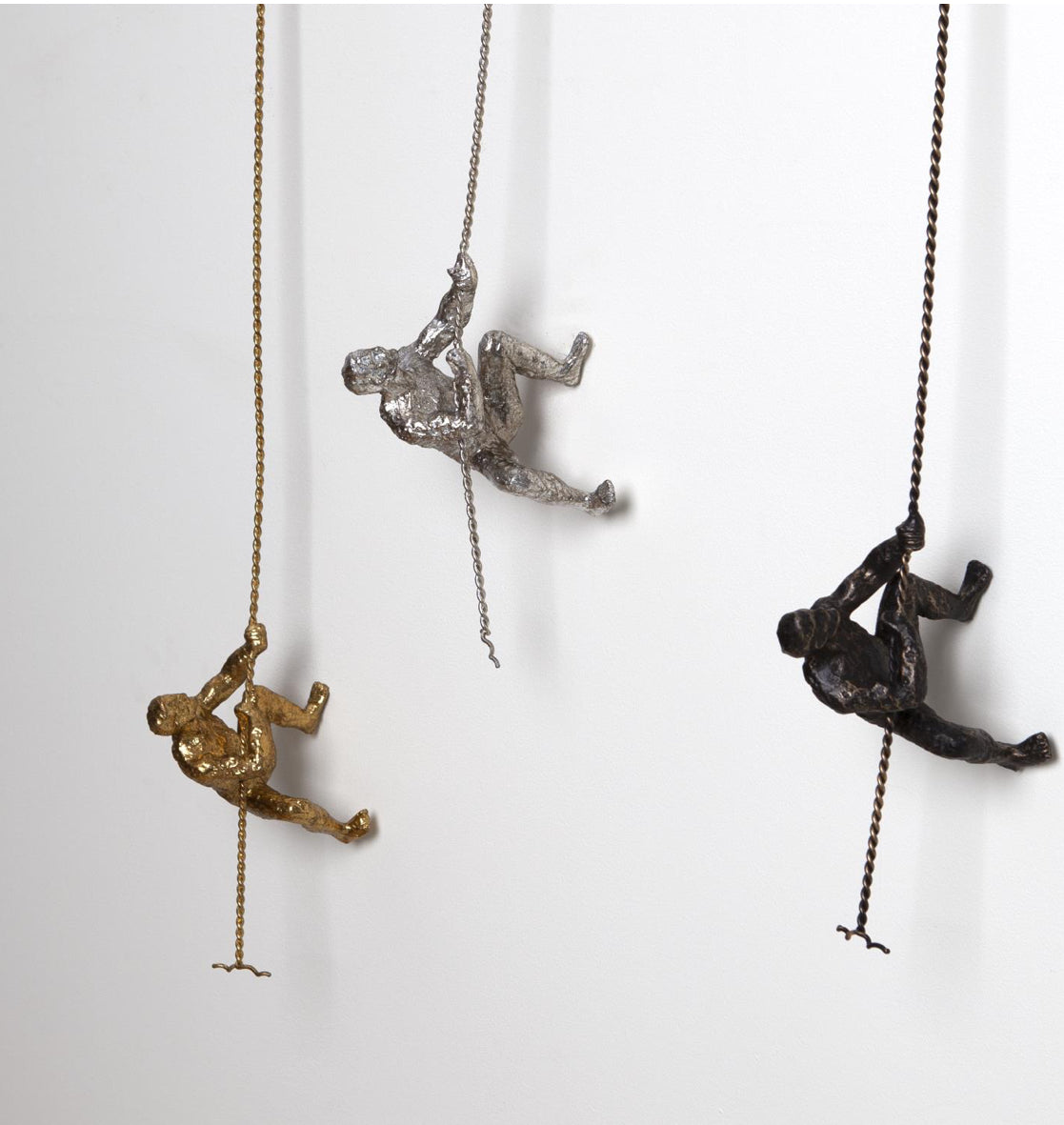 Climbing Man-Gold, Silver & Bronze Elevate The Originality Of Your Decor With Our Unique Climbing Man Wall Art A Stunning Illusion That Will Truly Enhances The Decor Of Your Home This high-end wall sculpture creates the illusion of a man climbing on any surface he treks. [Im A Striking 3-Dimensional Addition To Your Home.