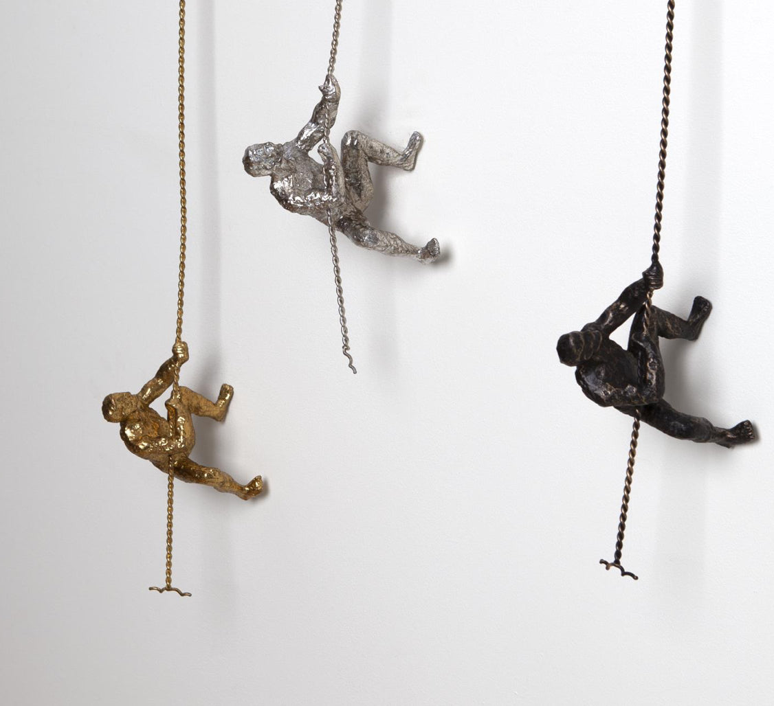 Climbing Man-Gold, Silver & Bronze Elevate The Originality Of Your Decor With Our Unique Climbing Man Wall Art A Stunning Illusion That Will Truly Enhances The Decor Of Your Home This high-end wall sculpture creates the illusion of a man climbing on any surface he treks. [Im A Striking 3-Dimensional Addition To Your Home.