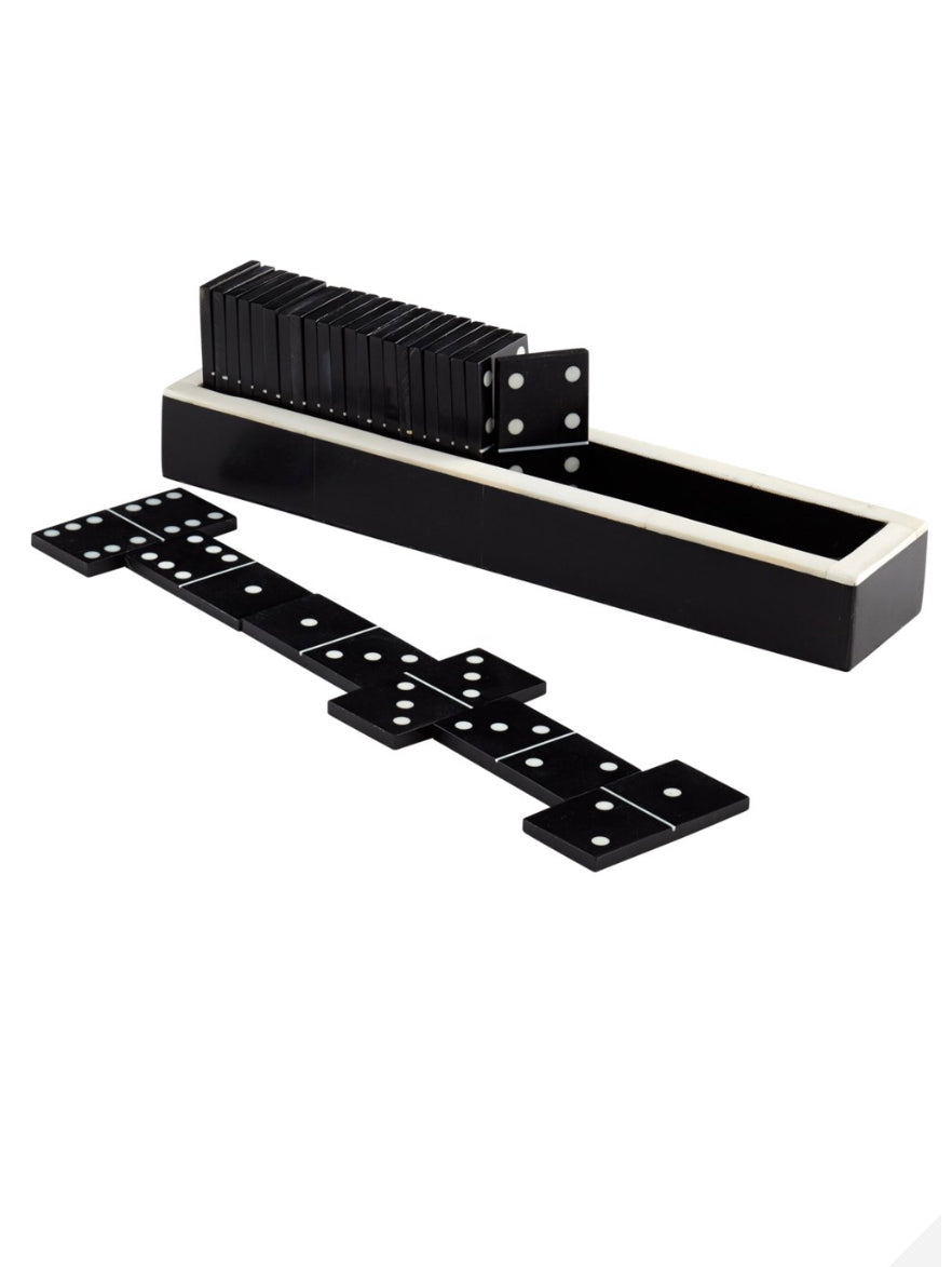    Dominoes  Bring an element of fun and strategy to a coffee table or a home office credenza with this game inspired dominoes sculpture. Interactively move the black and white pieces around for a fascinating and engaging artistic experience  Dimensions: H 2 x W 8.5 x Depth 1.75  Finish: Black and White Materials: Horn            