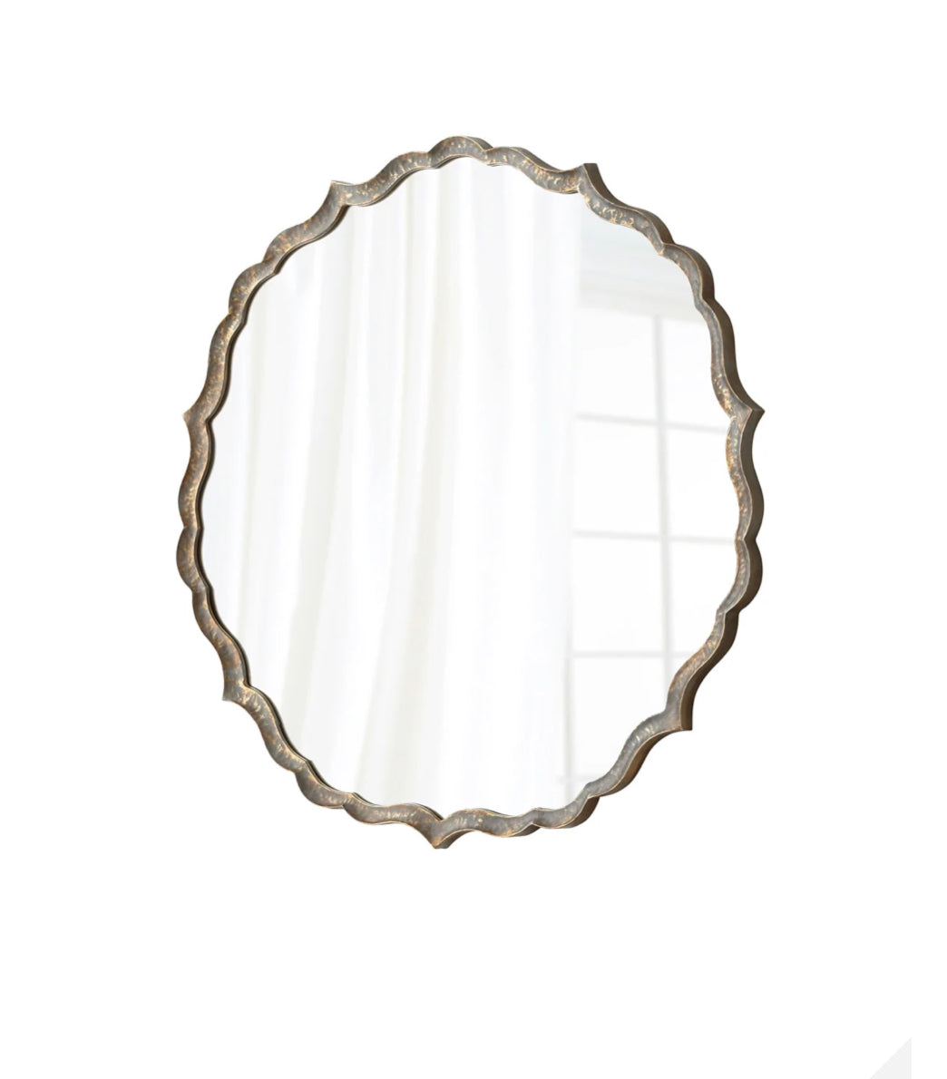 Add a modern twist to any bathroom or hallway with this interesting silver mirror. Cut out shapes add a contemporary spin to the classic frame.  Dimensions: Dia 44.25 x Ext 1.5  Weight: 38.55 lbs.  Qty Available: 24  Finish: Rustic Patina Materials: Iron and Mirrored Glass