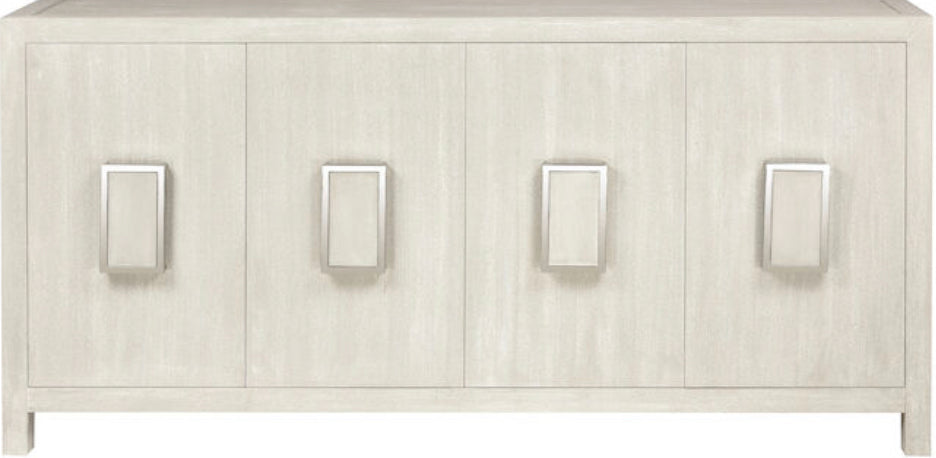 The Hawick Credenza is a striking four-door storage cabinet made from ash solids and veneer with a weathered white painted finish.   Each door features a central metal rectanglular door handle with a center panel made from the same cerused wood. Inner shelves within the cabinet offer ample storage.  Dimensions:72" W x 18" D x 36" H