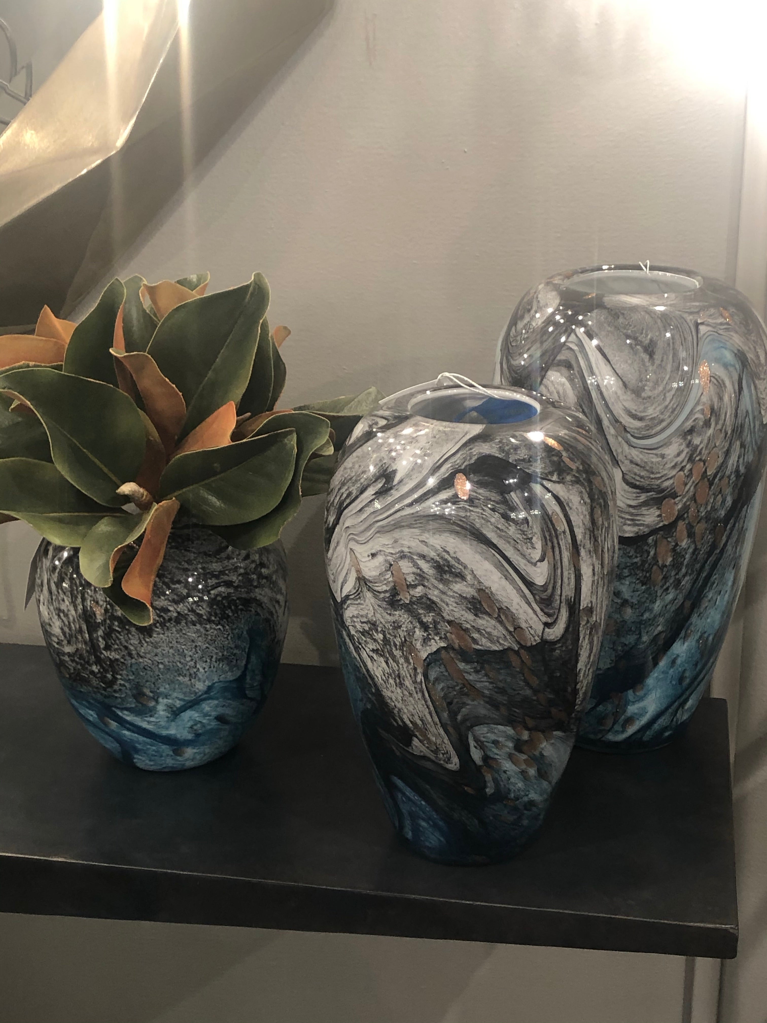 Color can make your space stand out, especially when displayed in unique patterns and formations. For this reason, the Prismatic tabletop vase is sure to add an instant boost to your design plans. Coated in a stunning multicolored gradient finish, this bud-shaped vessel showcases blue, green, grey, and gold splashes. Available in three size options, these rounded vases can create a head-turning display on your dining room table, living room coffee table, or any office bookshelf display  ETA: 5/20/22